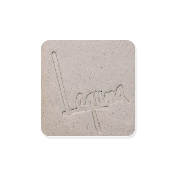 Laguna B-Mix 10 (WC379) clay test tile, light grey square with fine speckles and an impressed Laguna logo