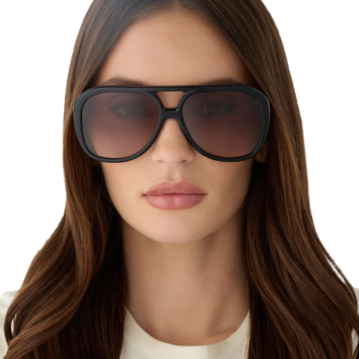 on model - female wearing for love & lemons x diff eyewear featuring the pauline aviator sunglasses with a black acetate frame and brown gradient lenses front view