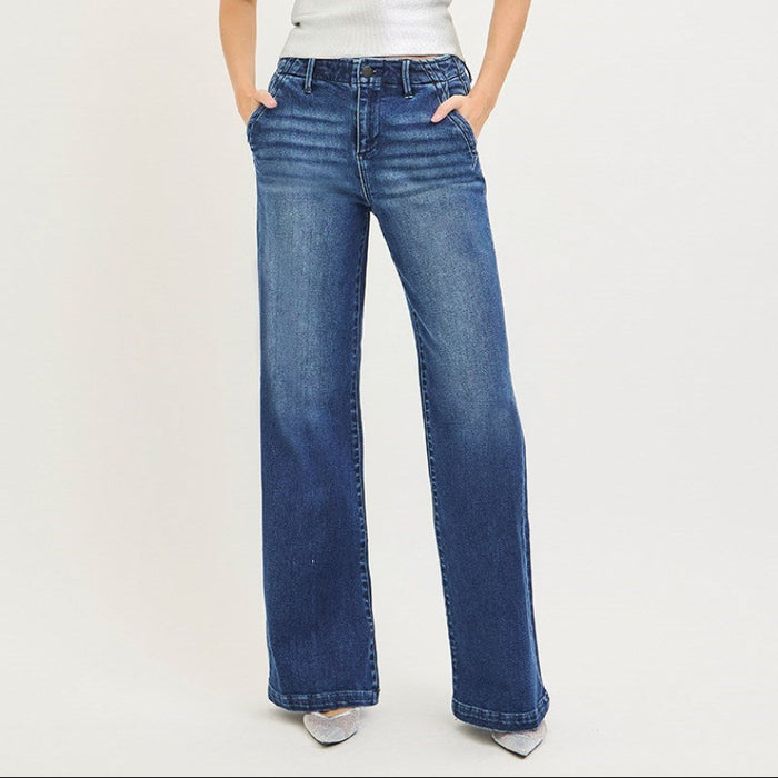 Woman wearing a white strapless top and blue jeans on a white background
