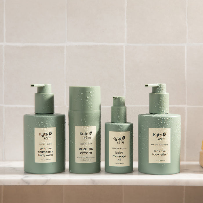 Set of Kyte Skin skincare products on a tiled bathroom shelf.