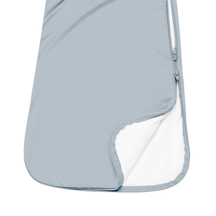 Close up of unzipped double zipper on Kyte Baby Sleep Bag in Fog 1.0
