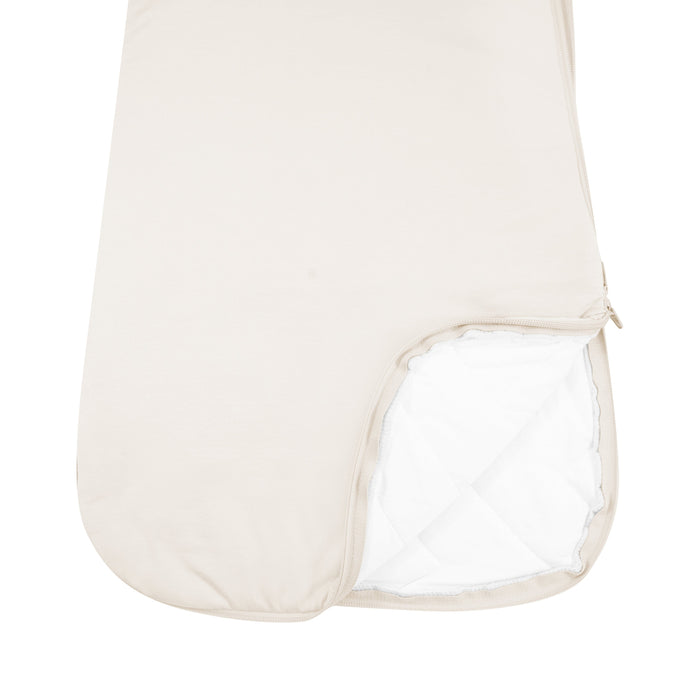Close up of unzipped dual zipper Kyte Baby Sleep Bag in Oat 2.5