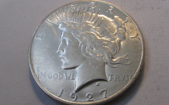 1927-D Peace Dollar.  AU-55 | Of Coins & Crystals