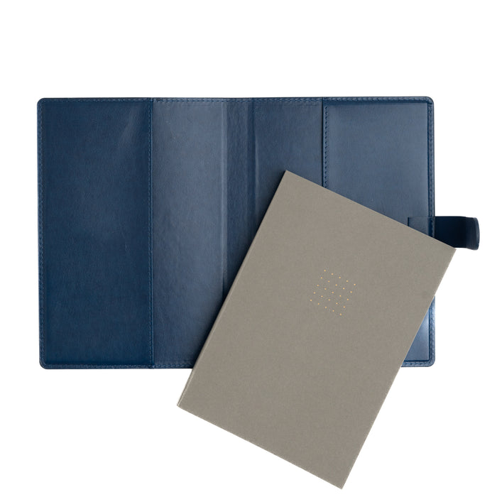 Blue leather-bound notebook with a beige cover on a white background