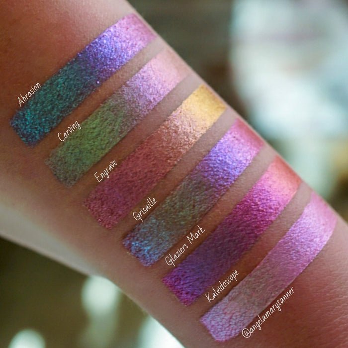 Left angled arm swatches on light skin tone of Abrasion Glitter Multichrome Eyeshadow shifts compared to Carving, Engrave, Grisaille, Glaziers Mark, Kaleidoscope