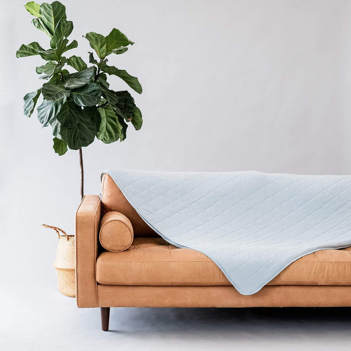 Couch with Kyte Baby Adult Quilted bamboo Blanket in Fog 1.0