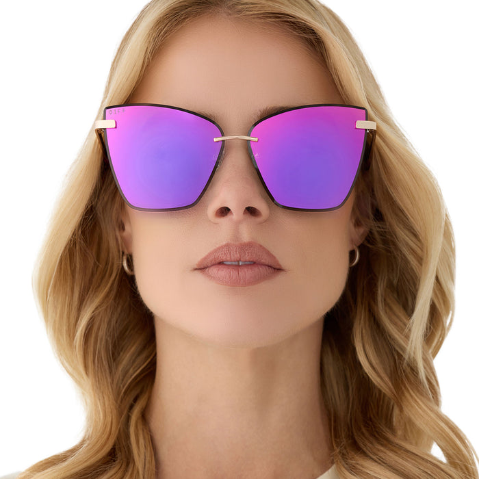 on model - female wearing diff eyewear featuring the becky v cat eye sunglasses with a gold frame and pink rush mirror lenses front view