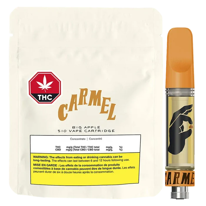 Front-facing shot of the Big Apple Pure Live Resin Vape Cartridge showing its orange-topped cartridge with a black hand logo beside a cream resealable pouch labeled "Carmel."