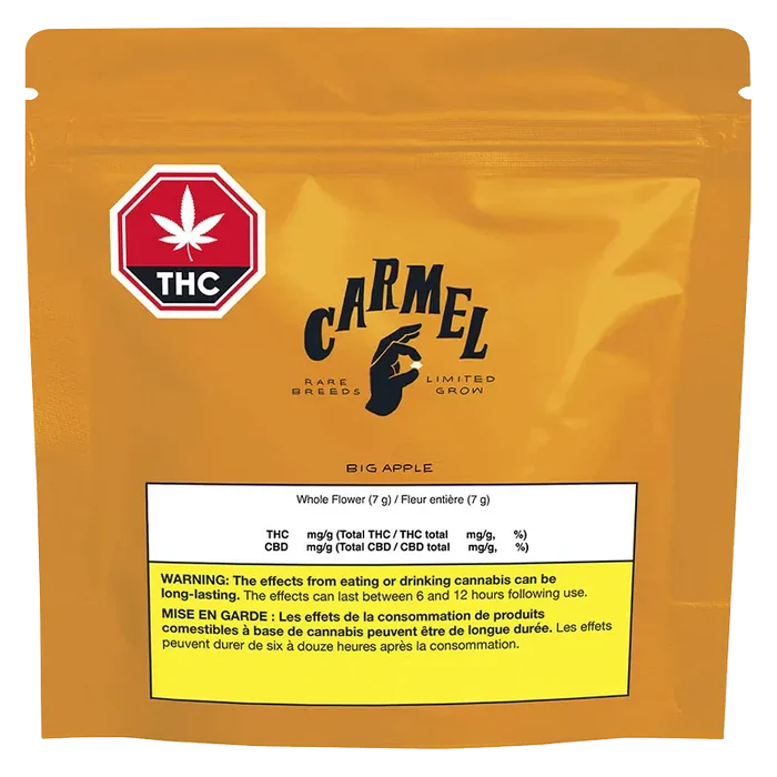 Front-facing shot of the orange Carmel Big Apple pouch with a red THC stop-sign logo and a white nutrition label near the bottom.
