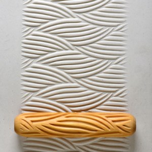 MKM Big Hand Roller BHR-11 Big Woven on a clay slab impressed with a large woven pattern of curved strands