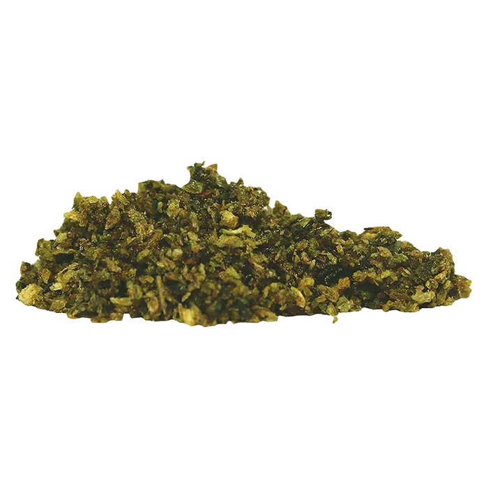 Low-angle close-up of a greenish pile of Blue Magoo Resin Infused Milled Flower against a white background.