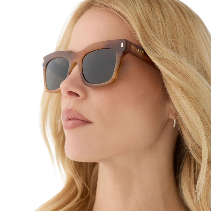 on model - female wearing diff eyewear featuring the bradley cateye sunglasses with a tawny brown tortoise frame and g15 polarized lenses angled view