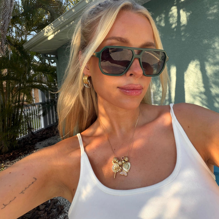 lifestyle - blonde model wearing green aviator navigator cameron sunglasses