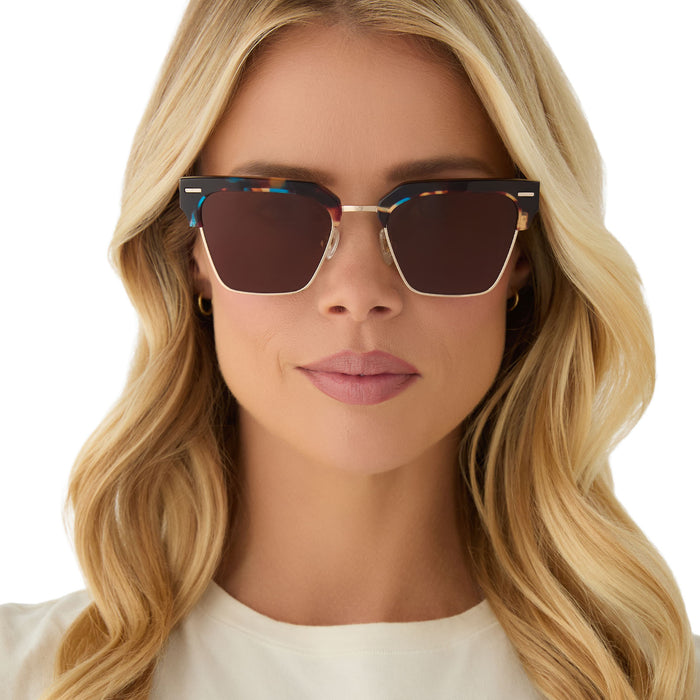 on model - female wearing diff eyewear featuring the capri rectangle sunglasses with a confetti tortoise frame and brown lenses front view