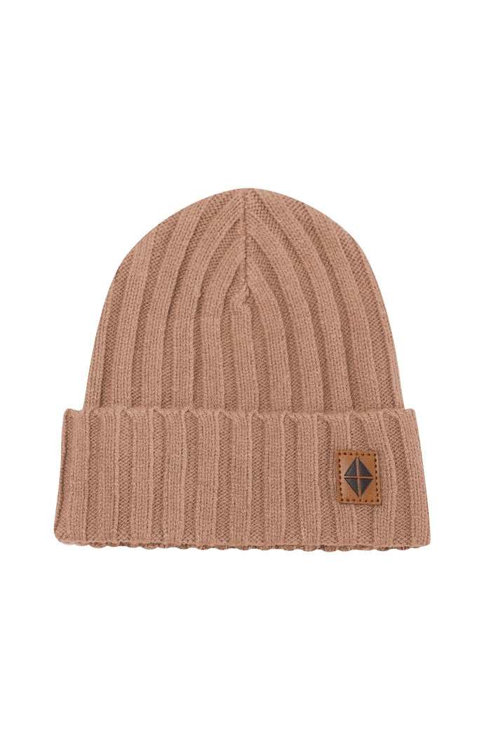 Product photo of the Chunky Knit Ribbed Beanie in Latte with the Kyte Baby vegan leather tag visible