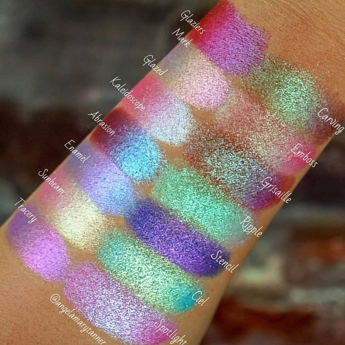 Top angled arm swatches on medium skin tone of Ciel Glitter Multichrome Eyeshadow shifts compared to Glaziers Mark, Glazed, Kaleidoscope, Abrasion, Enamel, Sunbeam, Tracery, Carving, Emboss, Grisaille, Ripple, Stencil, Spotlight