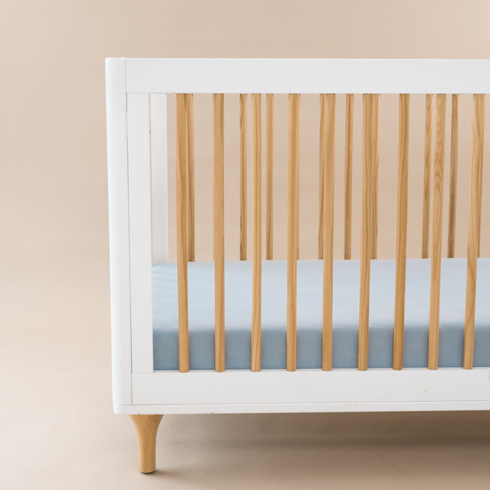 Crib Sheet in Fog shown on a mattress in a crib