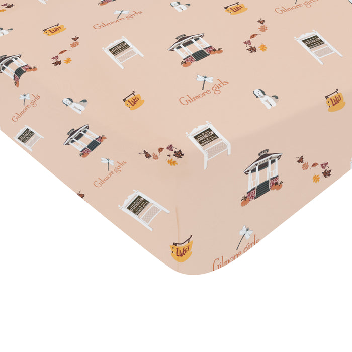 Patterned fabric with 'Gilmore Girls' logo and characters on a beige background