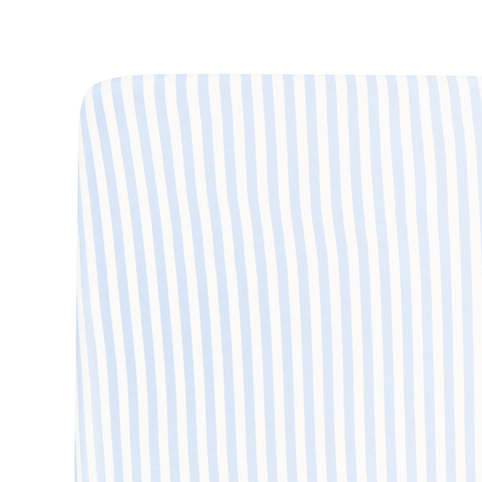 Close up of a corner of the Crib Sheet in Small Mist Stripe on a mattress