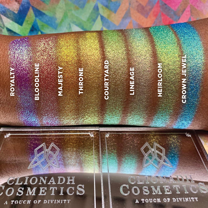 Top Angled arm swatches on deep skin tone of Crown Jewel Vibrant Multichrome Eyeshadow shifts in Vibrant Multichrome Bundle with Royalty, Bloodline, Majesty, Throne, Courtyard, Lineage, Heirloom