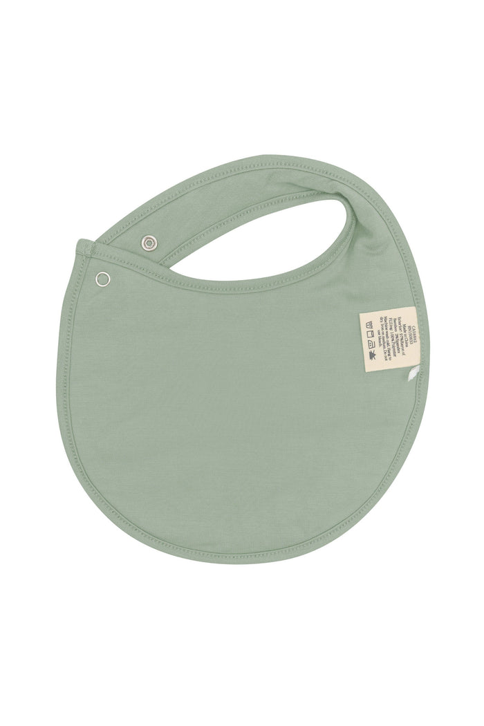 The back of the Cushy Bib in Silly Goose showing the Thyme color backside