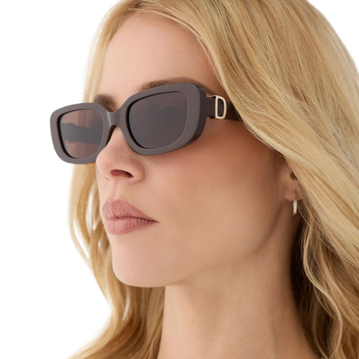 on model - female wearing diff eyewear featuring the daphne rectangle sunglasses with a truffle frame and truffle polarized lenses angled view