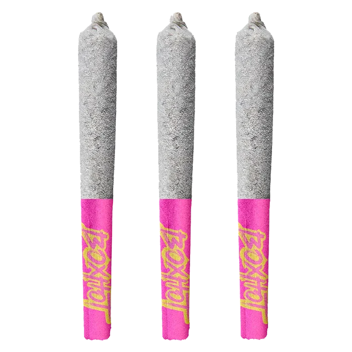 Three upright Dragon's Breath Infused PR 3 x 0.5 g pre-rolls with ash-tipped gray cones and bright pink Diamond Doobies branded tips.