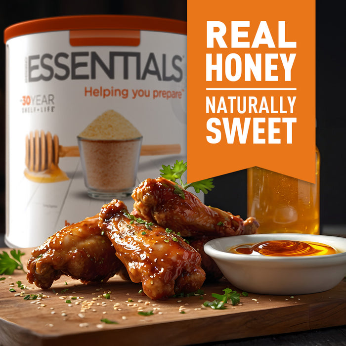 Honey glazed chicken wings with a bowl of honey and honey-glazed chicken on a cutting board