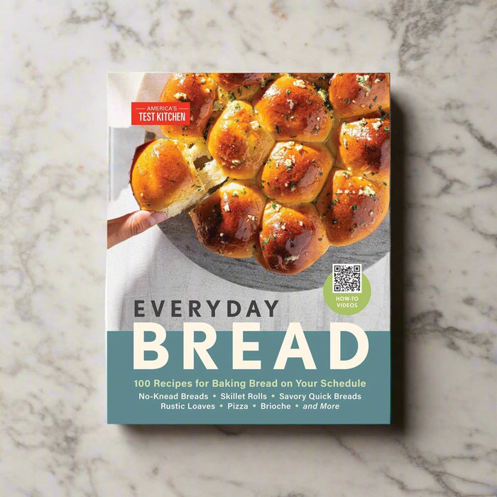 blue cookbook with picture of pull apart white rolls