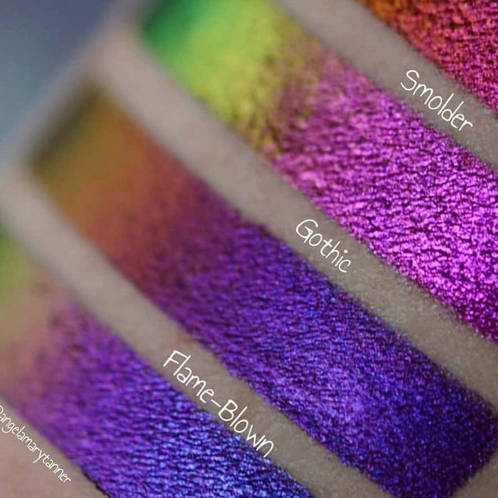 Right close up arm swatches on fair skin tone of Flame-Blown Jewelled Multichrome Eyeshadow compared to Smoulder, Gothic
