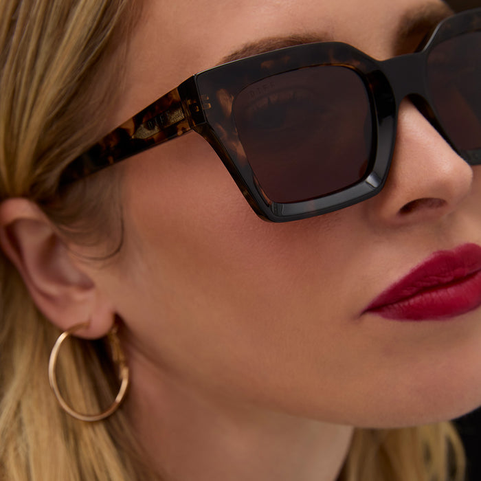 on model - female wearing diff eyewear featuring the greer square sunglasses with a espresso tortoise frame and brown gradient lenses detailed view