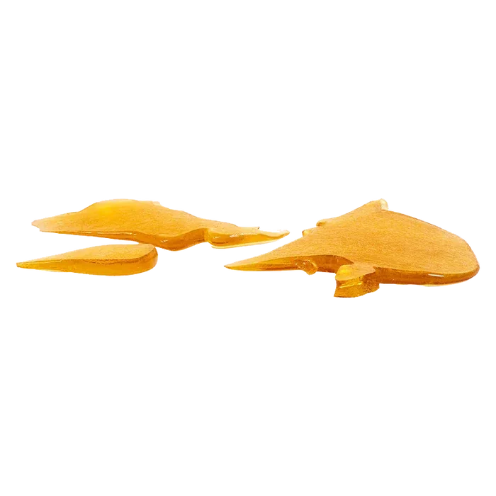 Low-angle close-up of amber-orange glass shards from House Shatter, scattered and reflecting light on a white background