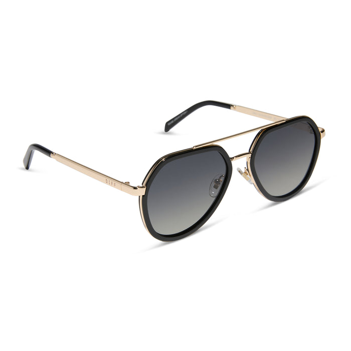 diff eyewear featuring the joey round sunglasses with a black & gold metal frame with grey gradient polarized lenses angled view