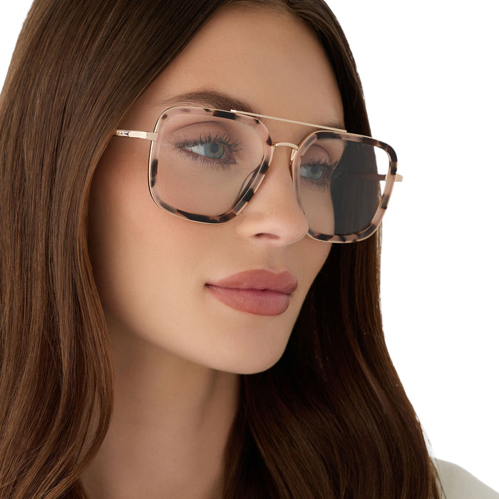 on model - female wearing diff eyewear featuring the jordan navigator prescription glasses with a himalayan tortoise and gold metal frame angled view