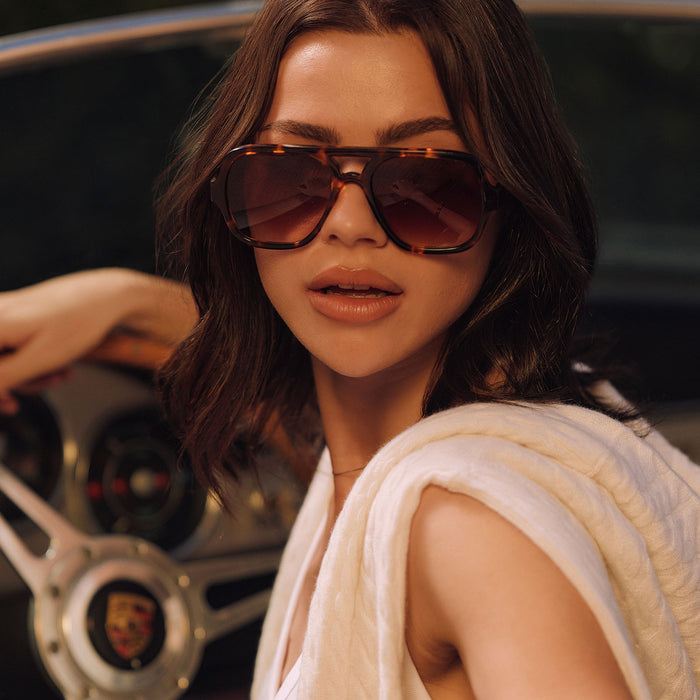 lifestyle - female in her car wearing on model - female wearing diff eyewear featuring the layton navigator sunglasses with a rich tortoise acetate frame and brown gradient lenses