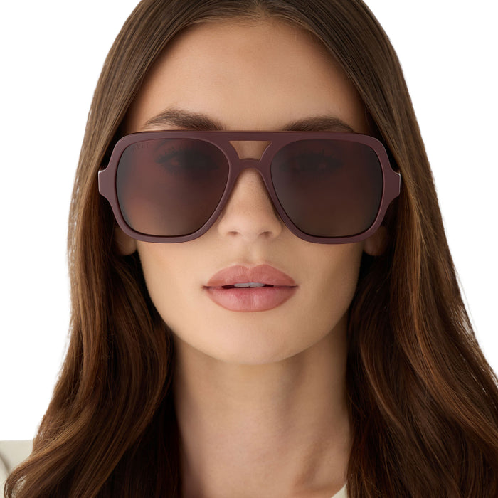 on model - female wearing diff eyewear featuring the layton navigator sunglasses with a rugby red acetate frame and brown gradient polarized lenses front view