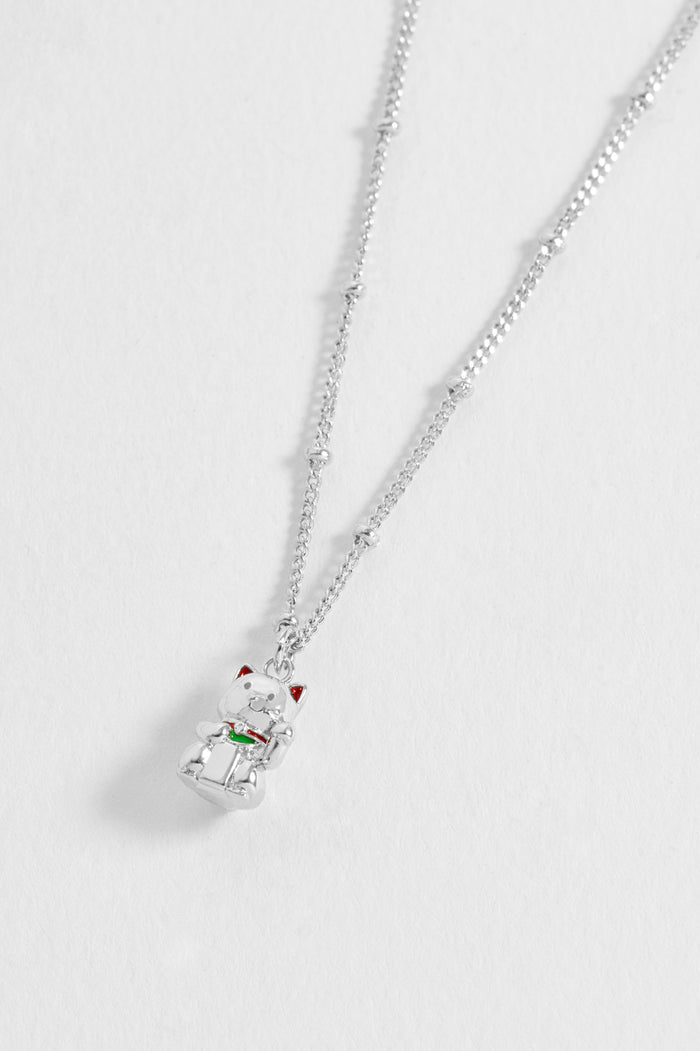 Silver necklace with a small pendant on a light gray background