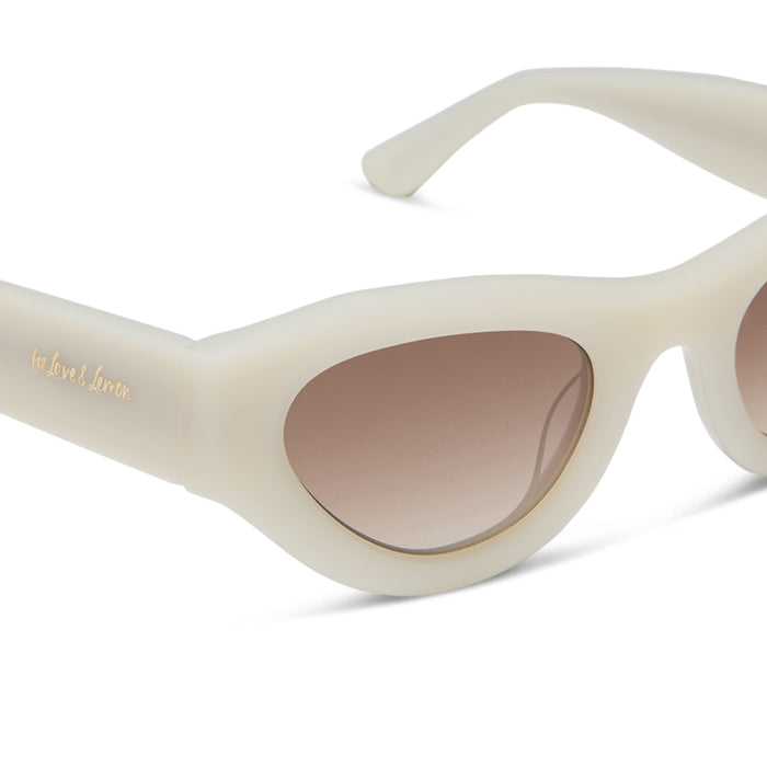 for love & lemons x diff eyewear featuring the lucy cat eye sunglasses with a meringue acetate frame and brown gradient lenses detailed view