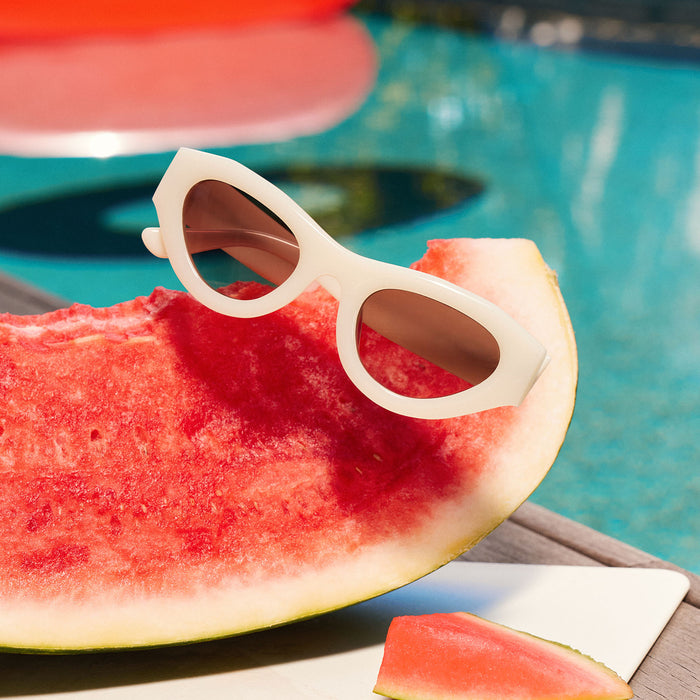 still life - for love & lemons x diff eyewear featuring the lucy cat eye sunglasses laying next to a pool
