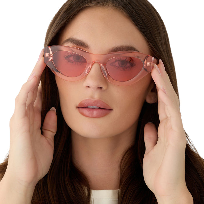 on model - female putting on for love & lemons x diff eyewear featuring the lucy cat eye sunglasses with a pastel pink acetate frame and rose pink lenses front view