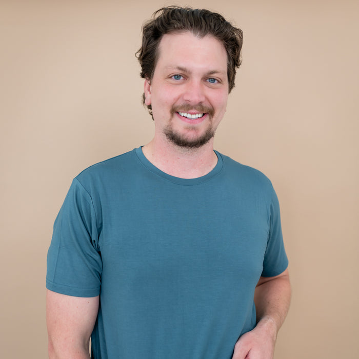 Close up of smiling male model wearing the Men's Crew Neck Tee in Atlantic