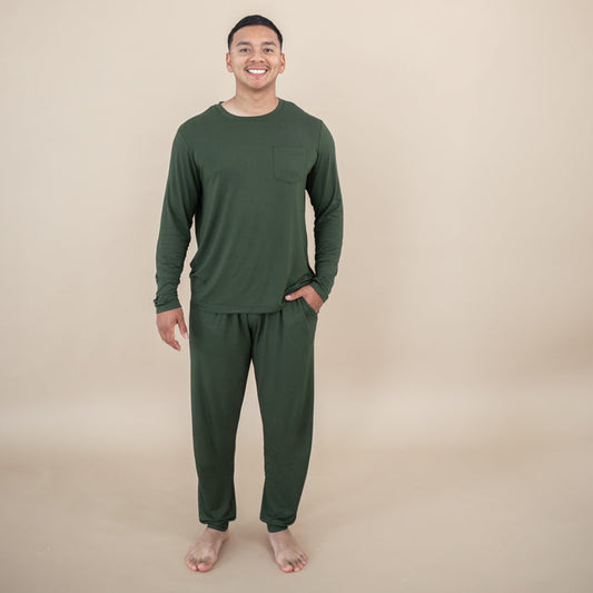 Man wearing a Men's Jogger Set in Fir against a beige background