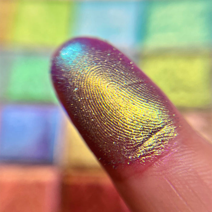 Close up finger swatch on fair skin tone of Niello Electric Multichrome Pigment