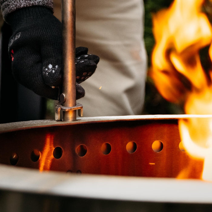 This is a picture demonstrating how to install the Outpost Rod into the X Series Firepit