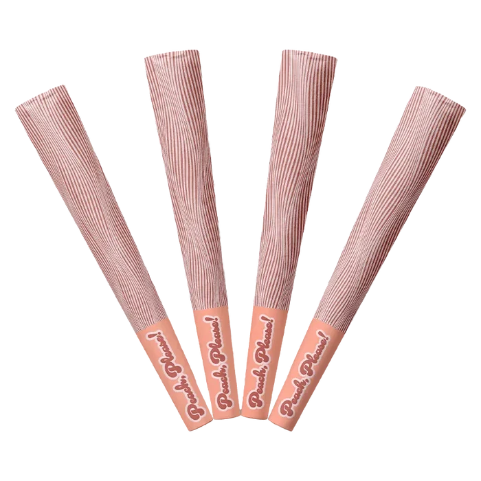 Top-down view of four peach-toned Peach Please PR 4 x 0.5 g sticks fanned out with striped wrappers and branded caps.