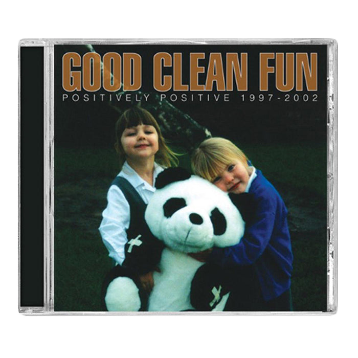 Two children smile and hug a giant panda plush on the cover of Good Clean Funs Positively Positive 1997-2002. Bold brown and white text highlights this album from the band, featuring rare punk tracks and unreleased music.