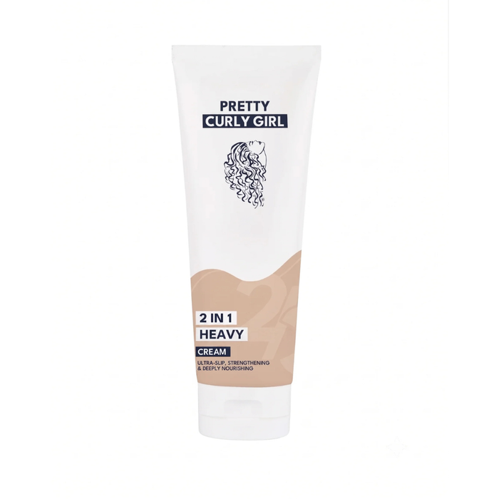 A white squeeze tube of Pretty Curly Girl 2 in 1 Heavy Cream hair product, featuring a beige wave graphic and black text, set against a plain white background.