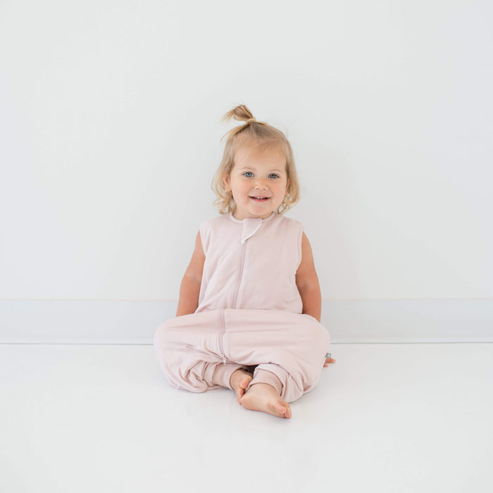 Toddler wearing Kyte Baby Sleep Bag Walker in Blush 2.5