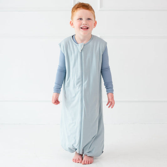 Child model smiling wearing the Sleep Bag Walker in Fog 1.0