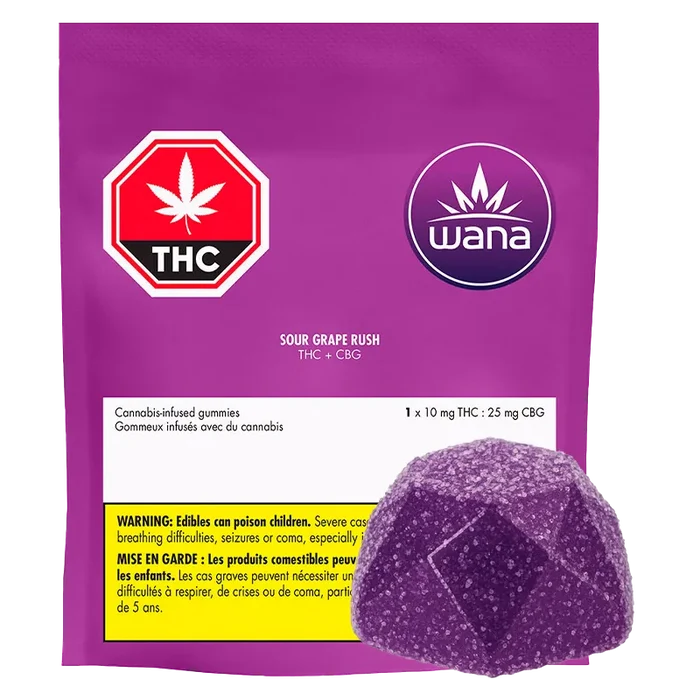 Front-facing shot of a purple pouch and single sugar-coated gummy labeled Wana Sour Grape Rush Gummies on a white background.